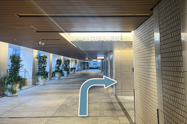 9.Enter through the entrance marked by the HOTEL METS logo; the front desk will be on your right.